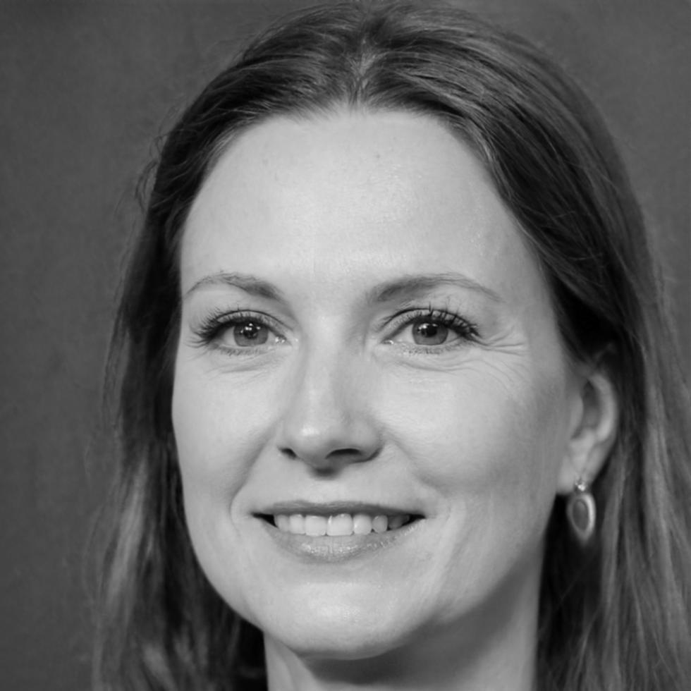 Senior economist Sarah Chen reviewing market analysis charts